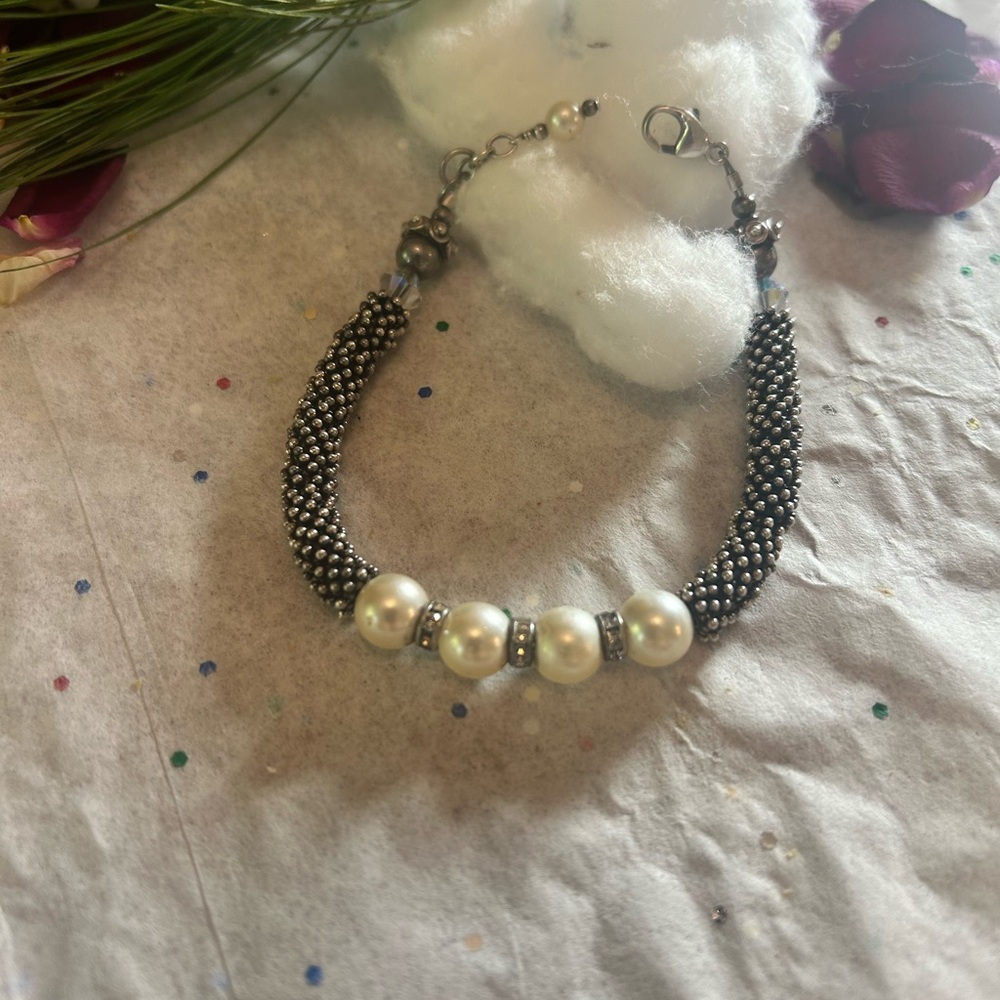 Sterling Silver bracelet with manufactured pearls.